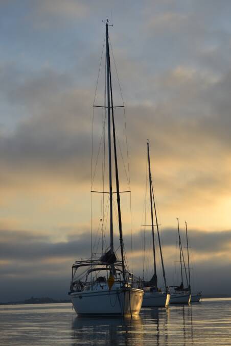 Sailboats off Wangi Wangi at dawn. Picture: Scott Bevan