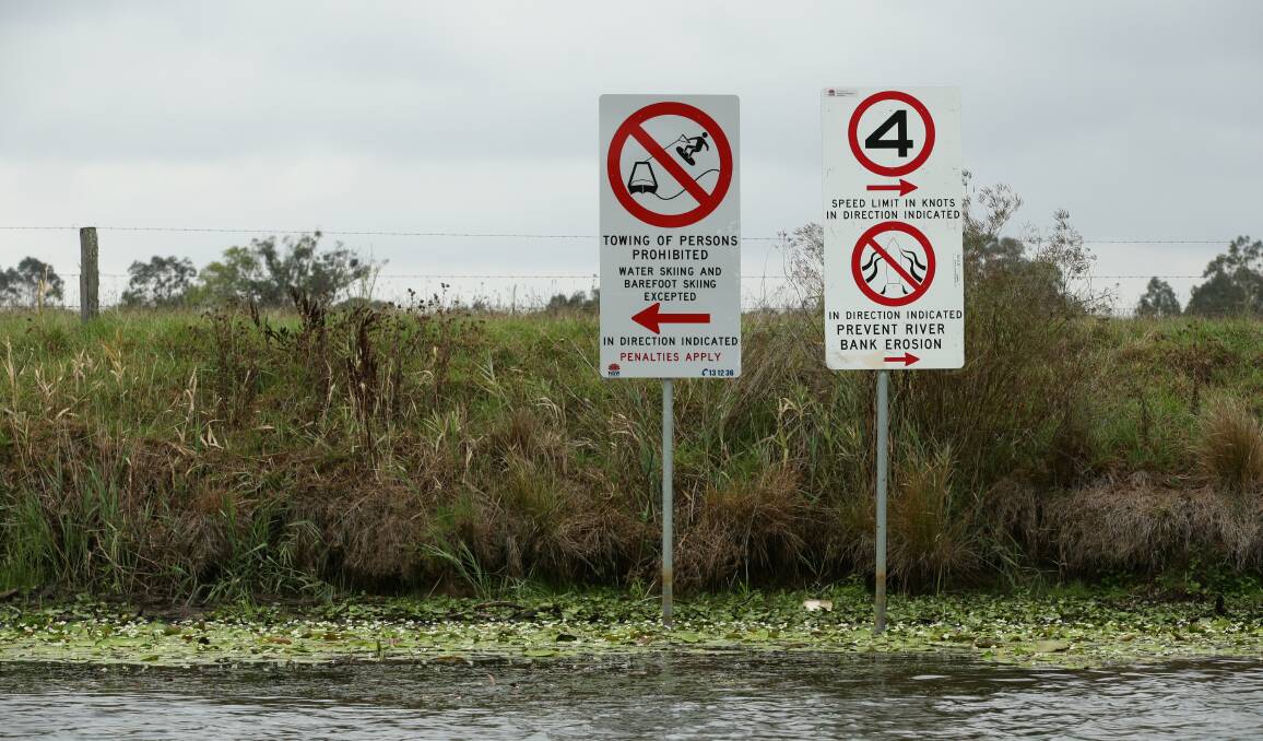 Boating signs on the bank of the Williams River. Picture: Simone De Peak