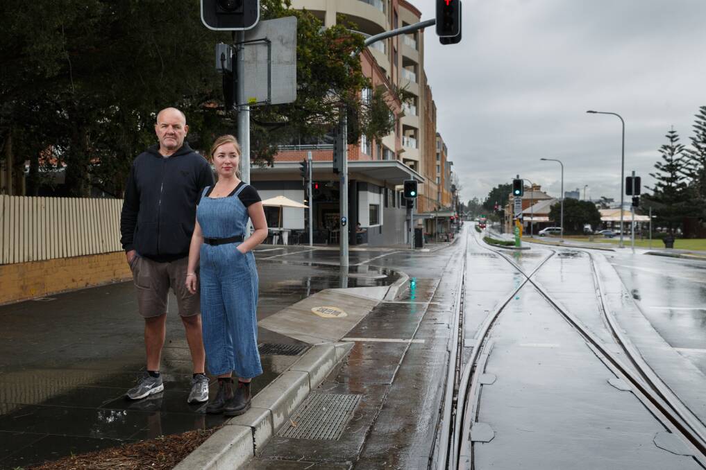 Peter Johnston, owner of 23hundred espresso bar, and cafe employee Rosie Scanlan beside the light rail tracks in Scott Street, Newcastle East. Picture: Max Mason-Hubers