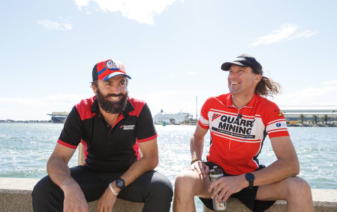 FLEET-FOOTED FRIENDS: Elite triathlete and coach Peter Hodgson with Rod Marshdale by Newcastle Harbour, as they prepare for the Ironman 70.3 race in Port Macquarie. Picture: Max Mason-Hubers 