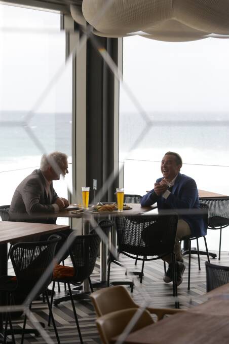 REFLECTING: Craig Rosevear talks with Scott Bevan about life and music, with his beloved Merewether surf in the background, far left. Picture: Jonathan Carroll
