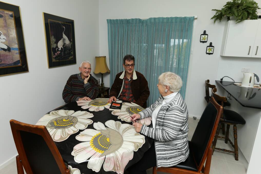 Author John Hughes with his parents, Bob and Val, in the family home dining room. Picture: Jonathan Carroll