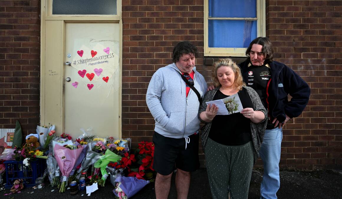 Jenny Allen, with her brothers David Sessions and Michael Sessions, reading cards left for their sibling, Bernie, outside his unit in 2017. Picture: Simone De Peak 
