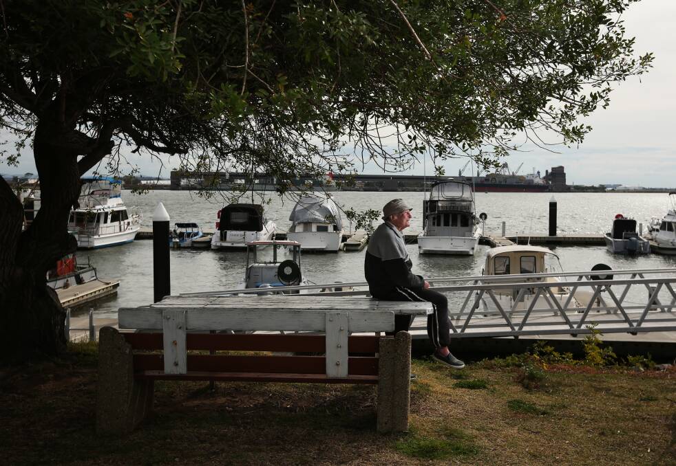 Reg Inglis sits under the Worry Tree along Stockton's western shore. Picture by Simone De Peak