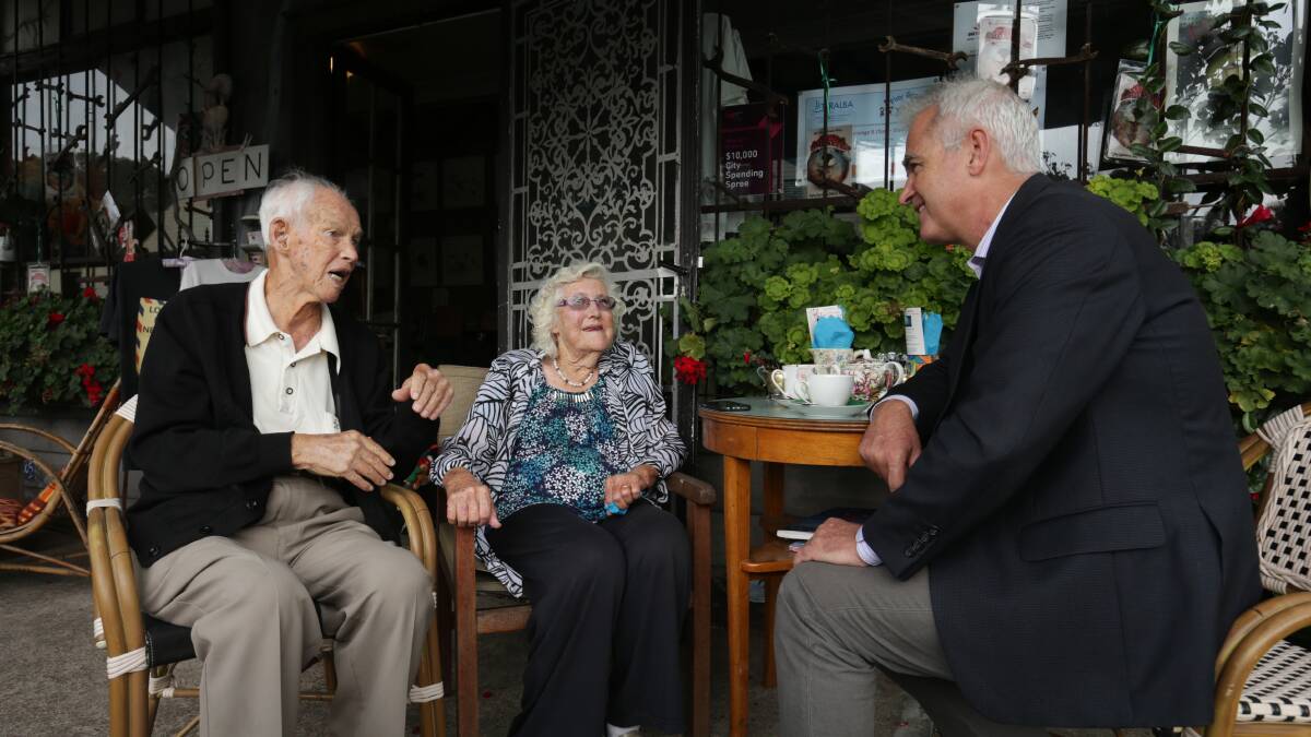 Ken and Betty Weatherstone chatting with Scott Bevan outside Flying Spanners gallery and cafe at Teralba. Picture: Simone De Peak
