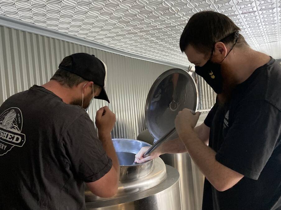 David "Jimmy" Cox and Nathan Lake creating beer at the Tinshed Brewery in Dungog. Picture: Haley Cox 