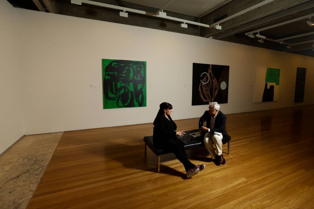 Newcastle Art Gallery director Lauretta Morton and writer Scott Bevan with paintings from The Erskine Pledge exhibition in the background. Picture: Jonathan Carroll