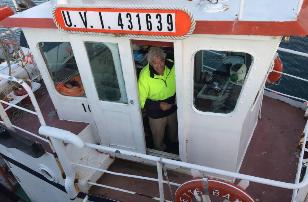 Bill Johnson in the wheelhouse of his tug, 'Betts Bay'. Picture: Scott Bevan
