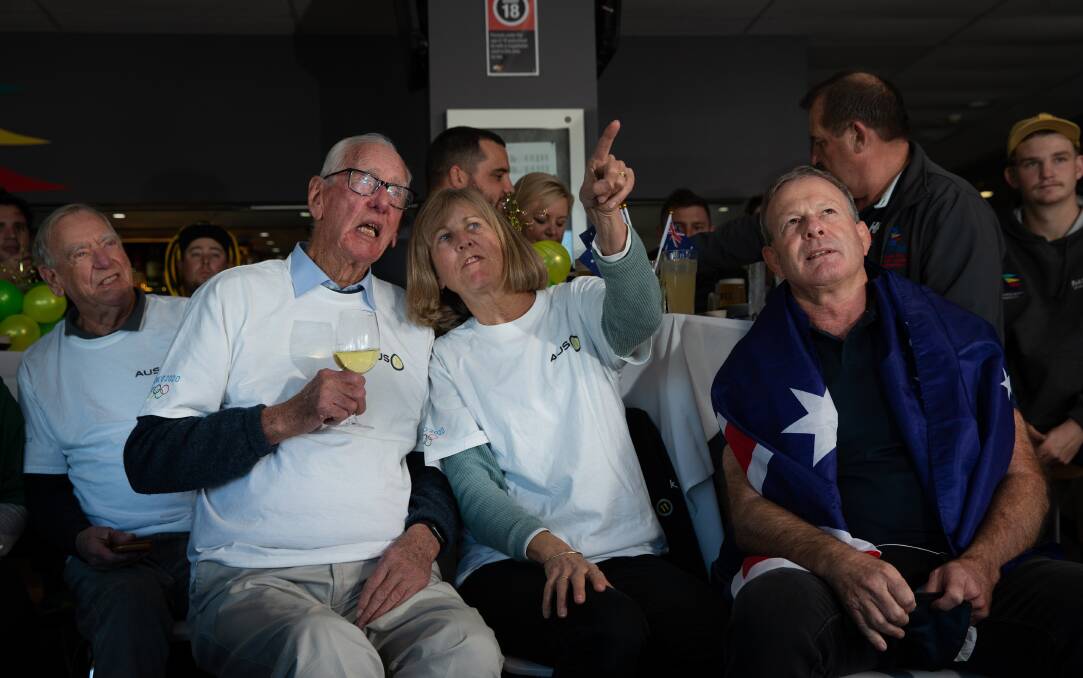 John Peschar, left, with Mandy and Frank Ryan at the gold medal party in Newcastle. Picture: Marina Neil
