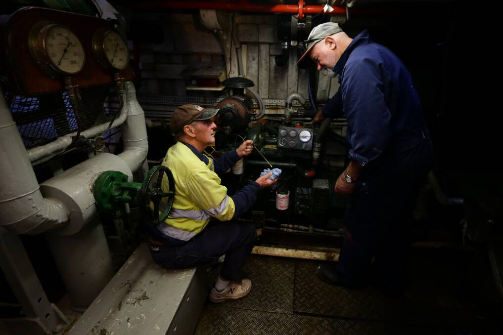 TEAM WORK: Volunteers Keith Lowe and Tony Druce checking the ship's engine.