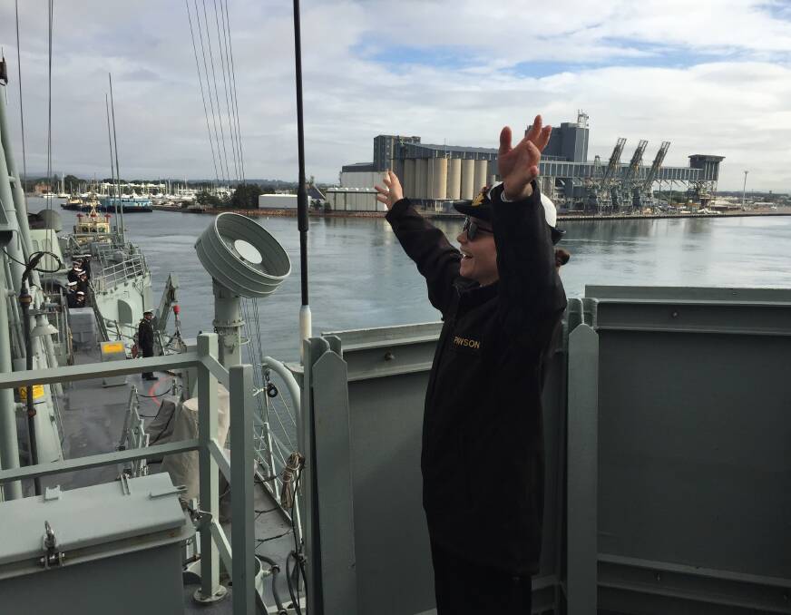 Sub Lieutenant Meg Powson waves farewell from HMAS Newcastle to Novocastrians. Picture: Scott Bevan 