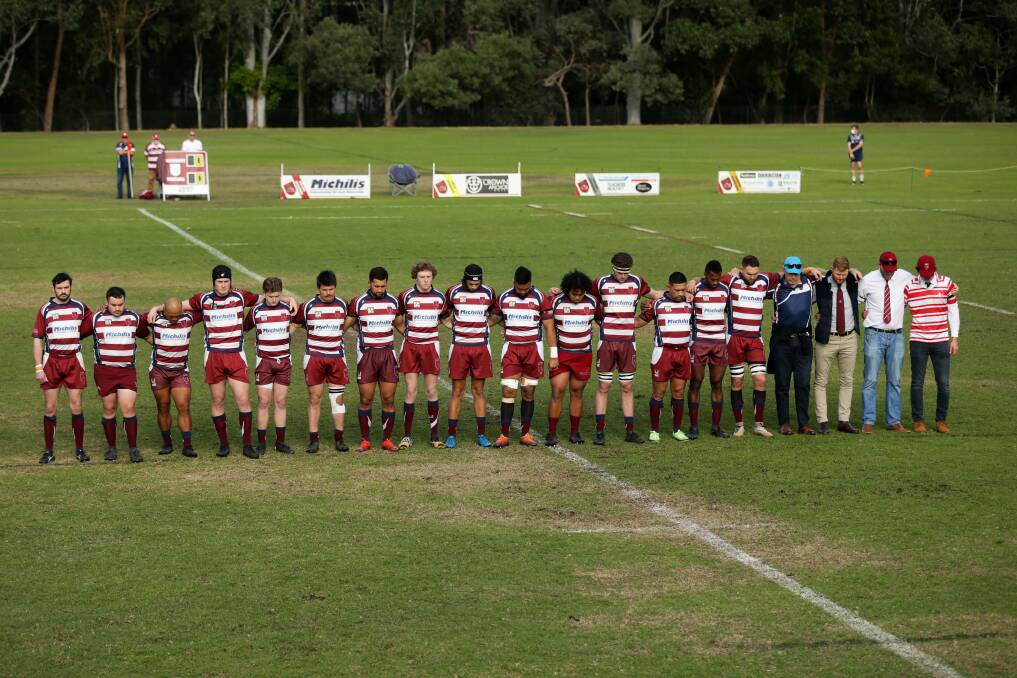 Players and officials of the University of Newcastle Rugby Union Club pay tribute to Bernie Curran the day after he died. Picture: Jonathan Carroll