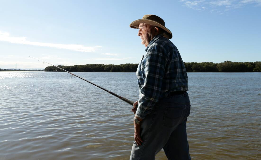 Author and fisherman Don Wilson by the Hunter River at Hexham. Picture: Jonathan Carroll