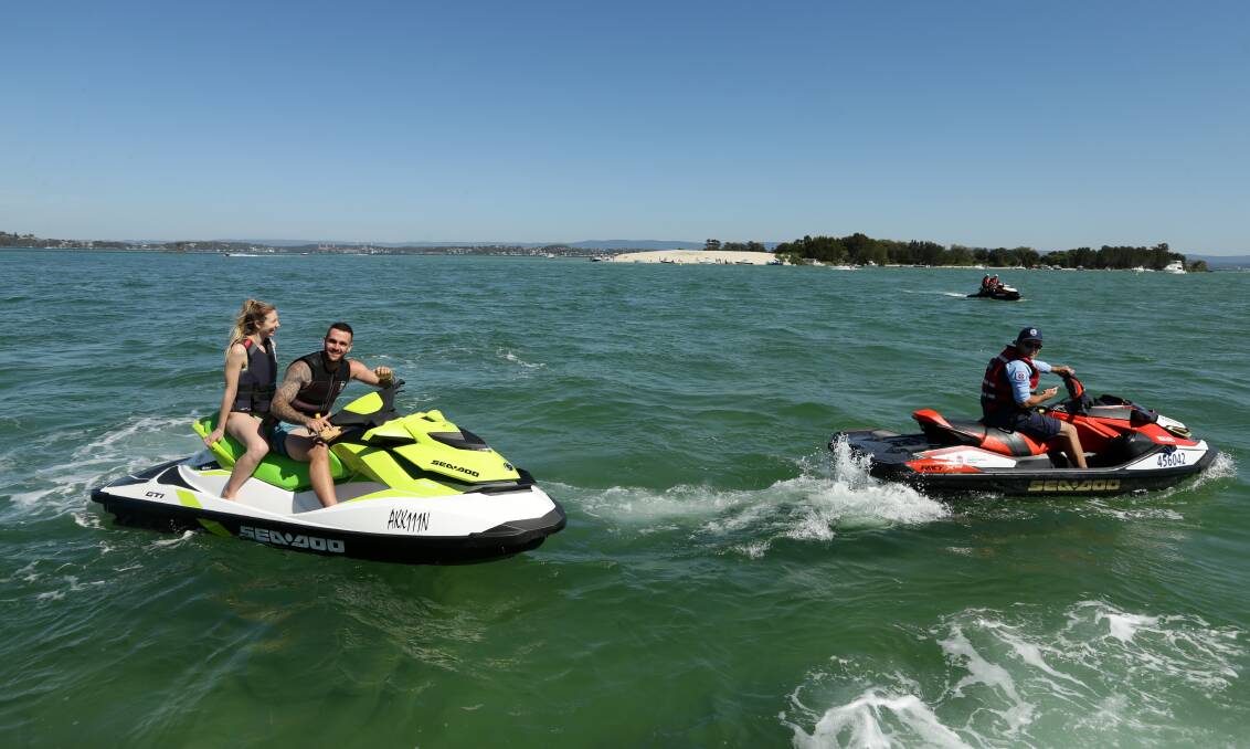Jet ski riders Holly Hayes and Joey Middleton with boating safety officer Chris Austen on Swansea Channel. Picture: Jonathan Carroll