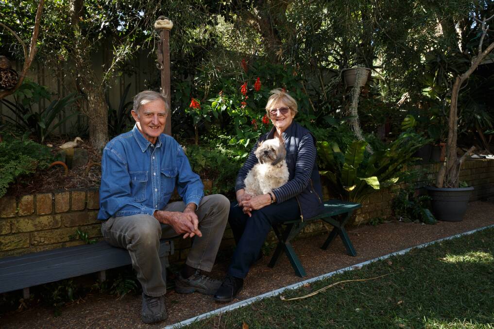 John and Pam Le Messurier, with their dog Molly, in their backyard, including the filled-in swimming pool. Picture: Max Mason-Hubers