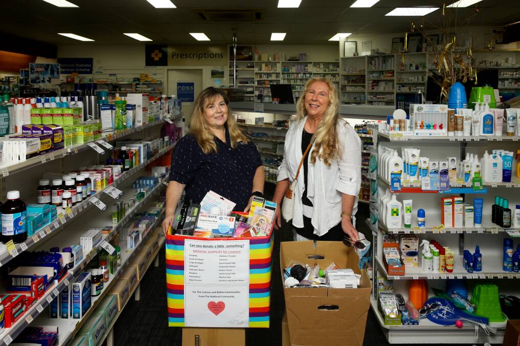 GENEROUS: Redhead Pharmacy's Tammy Ball and resident Deb Arthurs with two boxes filled with donated goods. Picture: Jonathan Carroll 