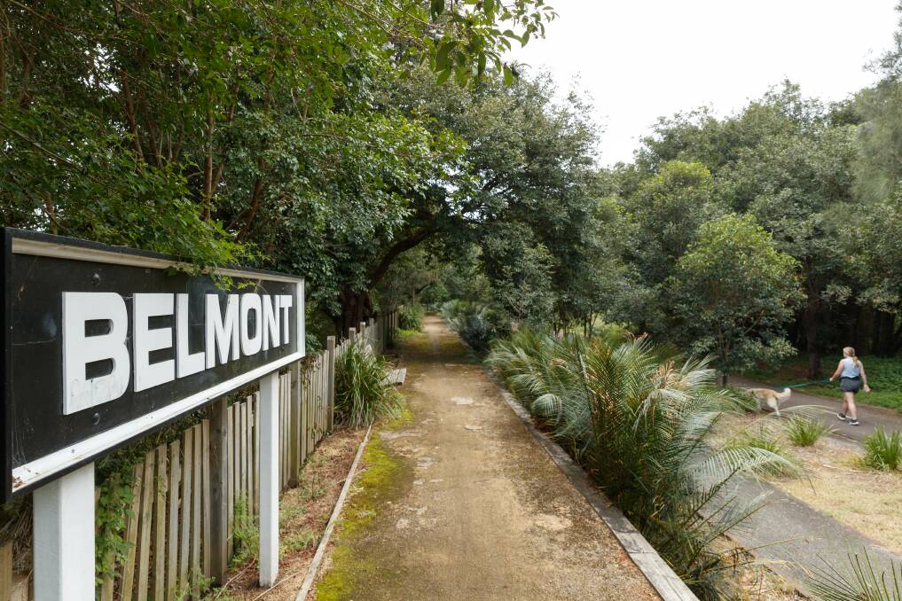 A walker on the Fernleigh Track passes the old Belmont station platform. Picture: Max Mason-Hubers 