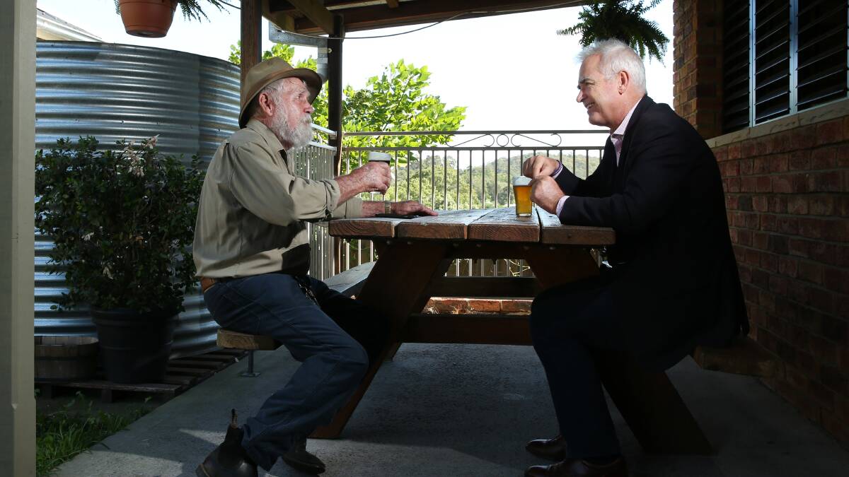 BUSH SETTING: Bob Skelton and Scott Bevan in the beer garden of the Minmi Hotel, just down the hill from the poet's house. Picture: Simone De Peak