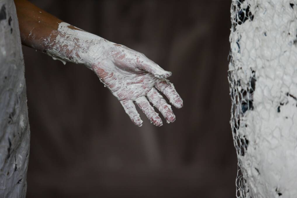 CREATIVE HAND: Lottie Consalvo sculpting her work, The Hug.
