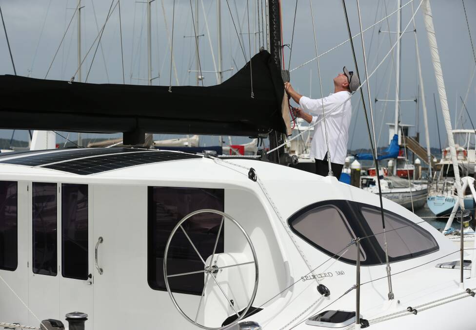 PREPARING: Garry van Dijk checks the rigging on his catamaran, Tasha, ready for the 24-hour race on the lake. Picture: Simone De Peak 