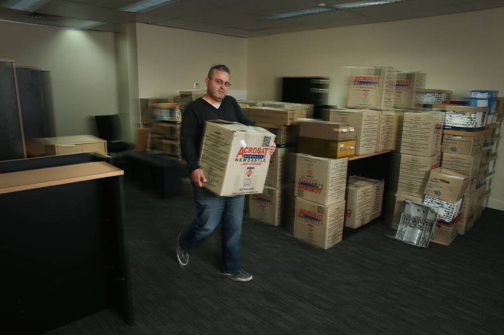 ON THE MOVE: Ross Mason, director of Mason Lawyers, carrying a box into his new premises at Mayfield, as the legal business shifts from its office of 18 years in the Civic precinct. Picture: Marina Neil 