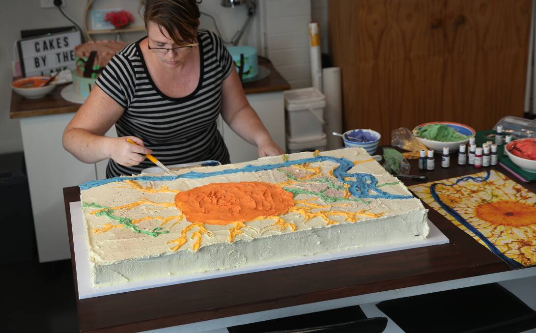 Sweet creation: Cake decorator Charmaine Sheehan recreating John Olsen's painting 'King Sun & the Hunter' for the artist's birthday party at Newcastle Art Gallery. Picture: Marina Neil