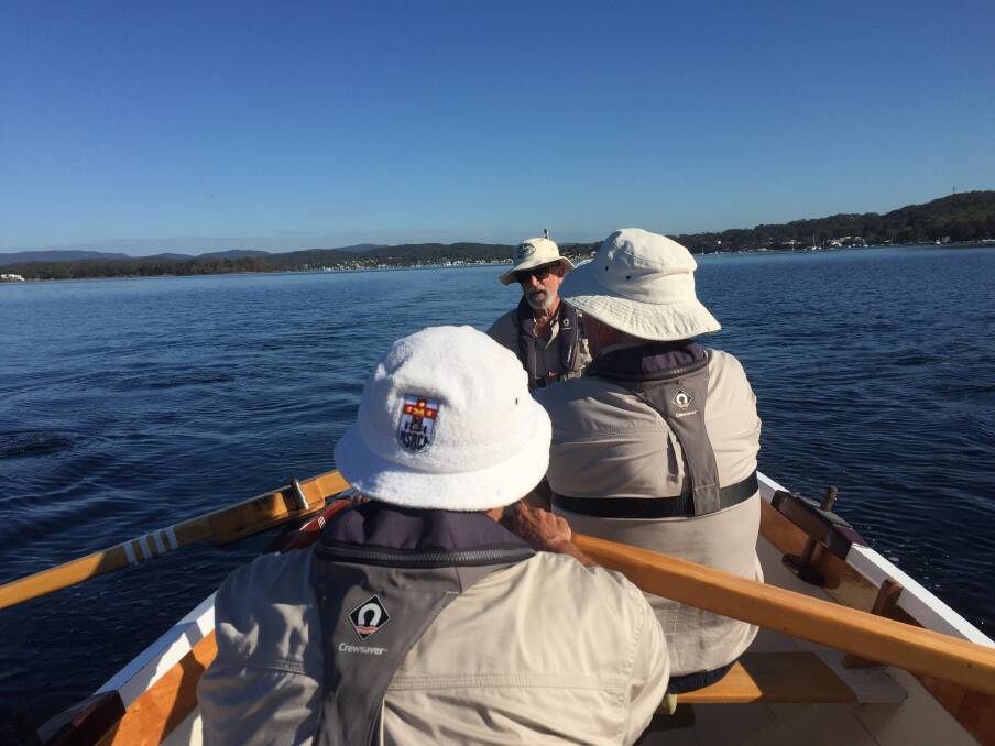 Members of Lake Macquarie Classic Boat Association rowing their vessel, "Catalina", off the Rathmines shoreline. Picture: Scott Bevan