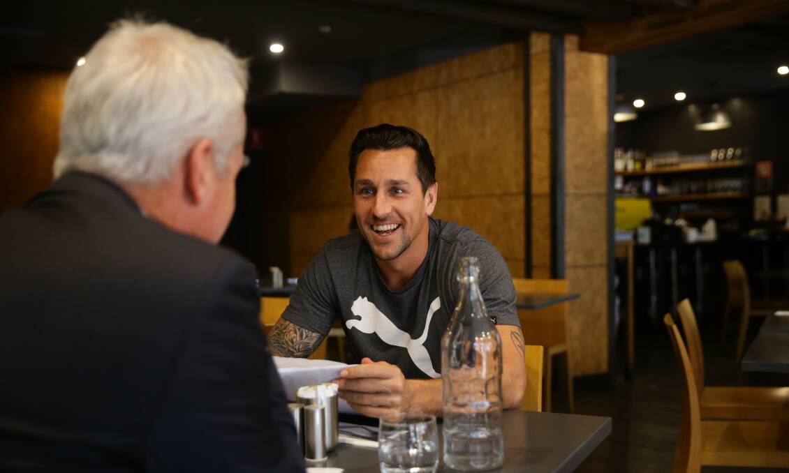 LUNCH CHAT: Mitchell Pearce talking with Scott Bevan. Picture: Jonathan Carroll