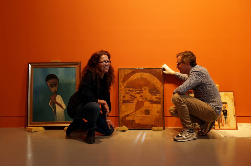 Curators Meryl Ryan and Damian Smith inspect works in the "be" exhibition. Picture: Simone De Peak.
