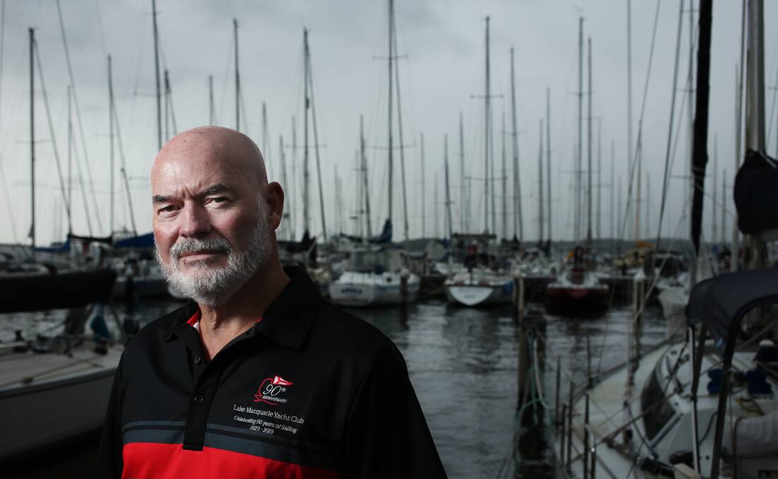 Commodore of Lake Macquarie Yacht Club Geoff Edman, with the club's marina in the background. Picture: Simone De Peak 