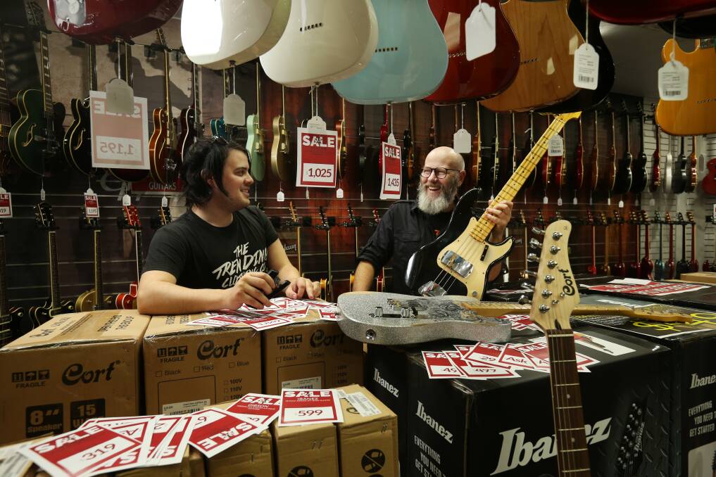 Musos' Corner employees Greg Sher and Sean Smith prepare for the "May the Fourth Be With You" sale. Picture: Simone De Peak 