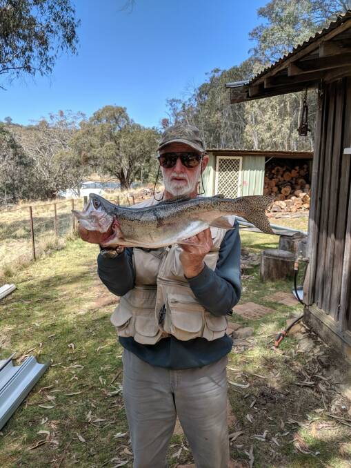 Barry Brown with the trout he caught in Bottom Dam. Picture: Charles Atkin