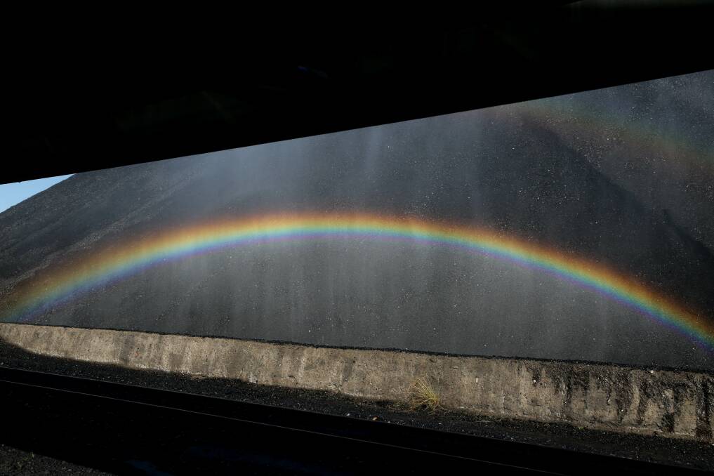 Rainbow formed by water sprayed on the coal stockpile. Picture: Jonathan Carroll 