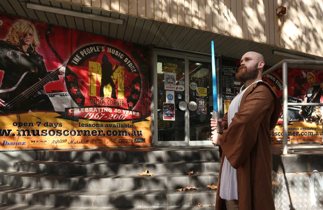 FEELING THE FORCE: Guitarist, 'Star Wars' fan and keen bargain hunter Nathan Field waits for the annual 'May the Fourth Be With You' sale at Musos' Corner, with the doors opening at 10am Tuesday. Picture: Simone De Peak 