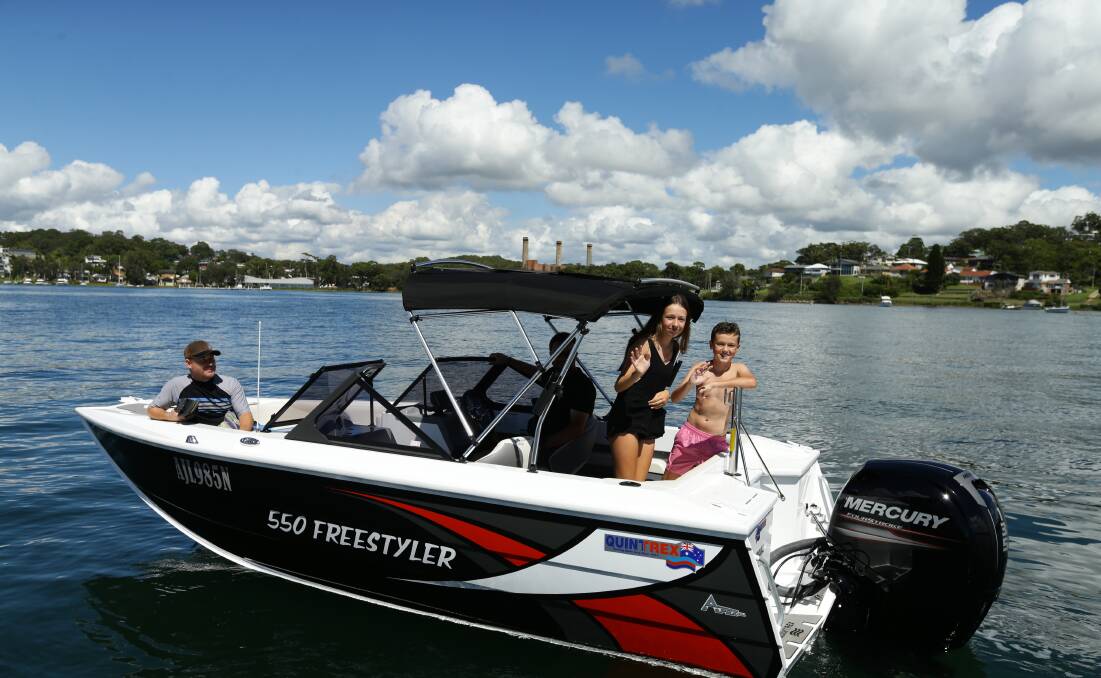 Ciara and Jack Ryan on their family's boat in Wangi Bay. Picture: Jonathan Carroll 