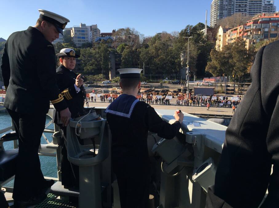 HMAS Newcastle arrives at Fleet Base East, as a crowd of loved ones wait on the wharf. Picture: Scott Bevan