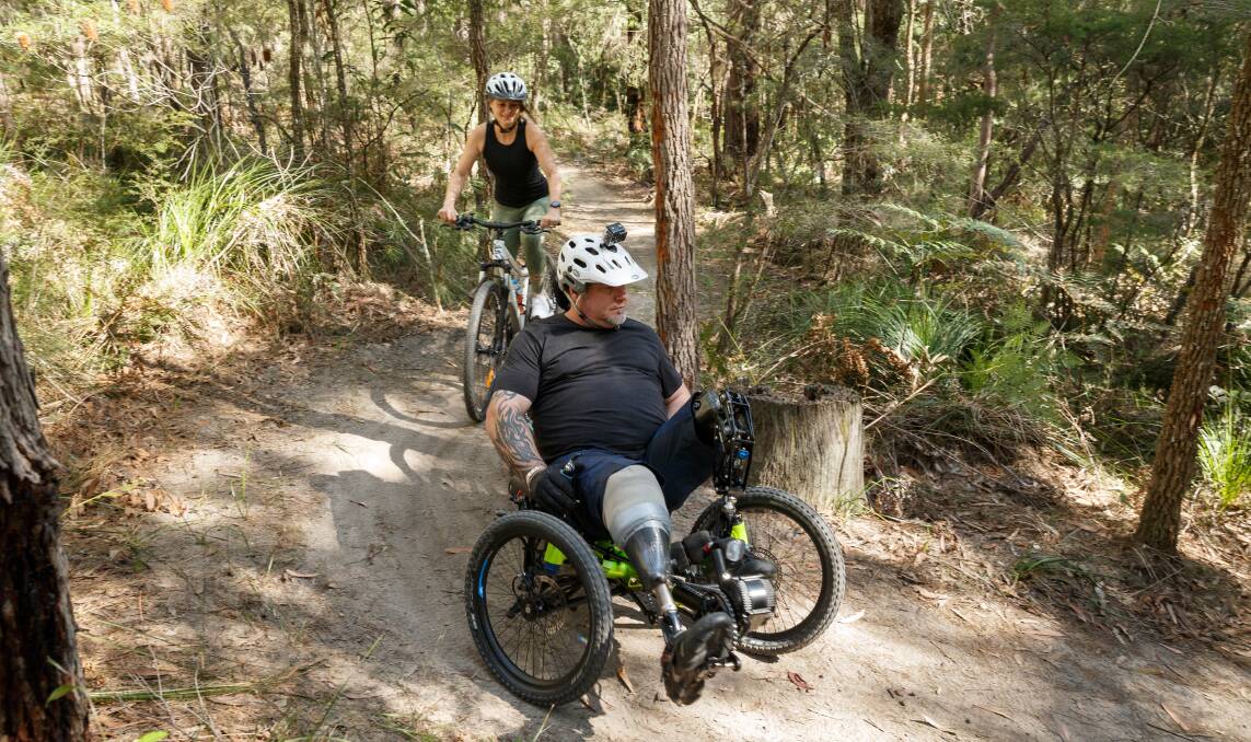 FREEDOM: Scott Edgar with support rider Kristen Hardcastle on the development trail at the Awaba Mountain Bike Park. Picture: Max Mason-Hubers