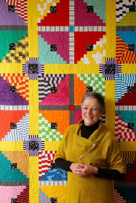 Textile artist Judy Hooworth with one of her quilts. Picture: Jonathan Carroll