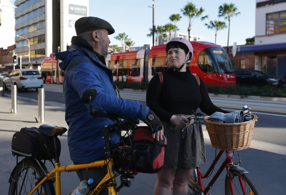 University student and cyclist Emmalee Ford speaks with Sam Reich, from Newcastle Cycleways Movement, in Hunter Street. Picture: Simone De Peak 