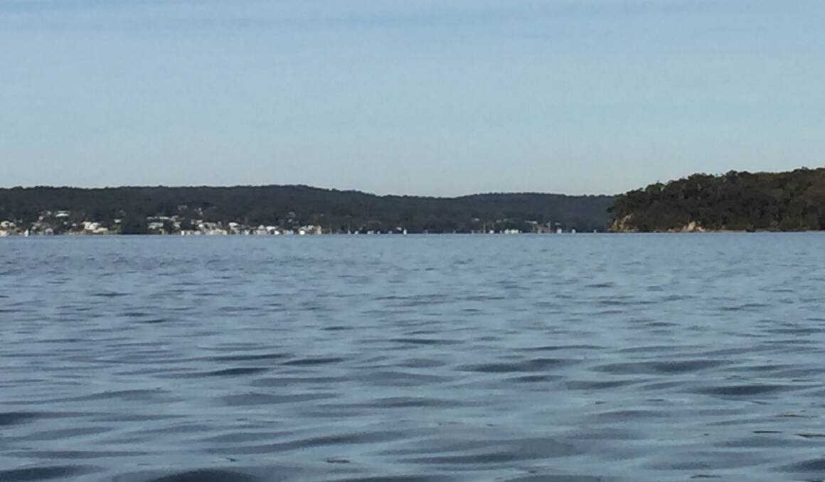 One lake, two worlds: On the left, the village of Nords Wharf is not in the Greater Sydney lockdown, but Point Wolstoncroft and Gwandalan, on the right, are part of those orders. 