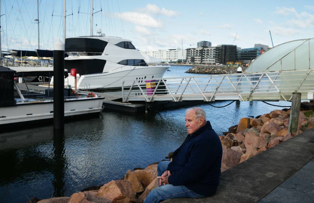 Retired seafarer Tom Jones sits by the harbour, near where fuel was unloaded from the ship he worked on, the "John Hunter". Picture: Jonathan Carroll 