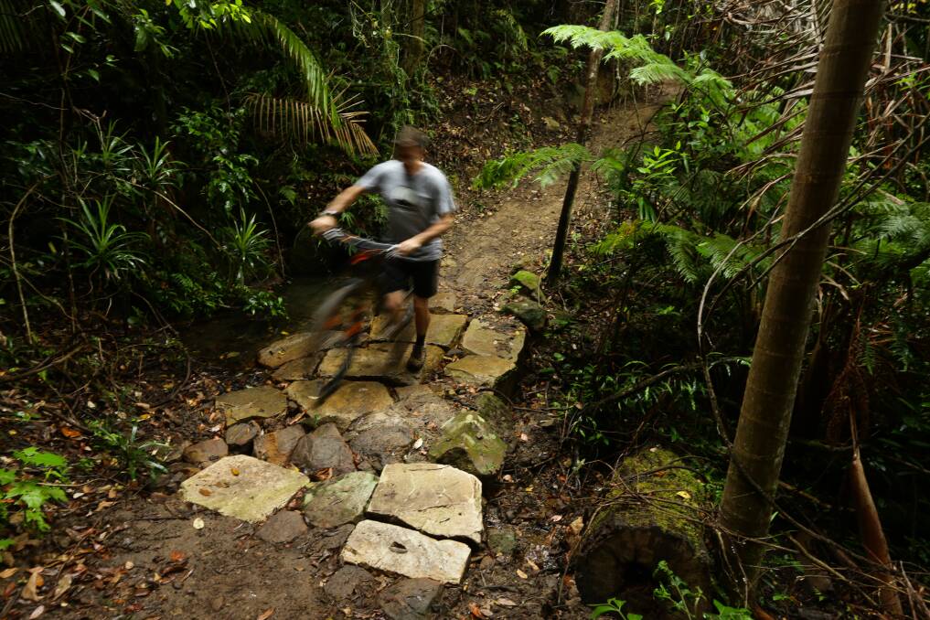 NATURAL PATH: Dallas Barham uses a newly built stone crossing over a watercourse.