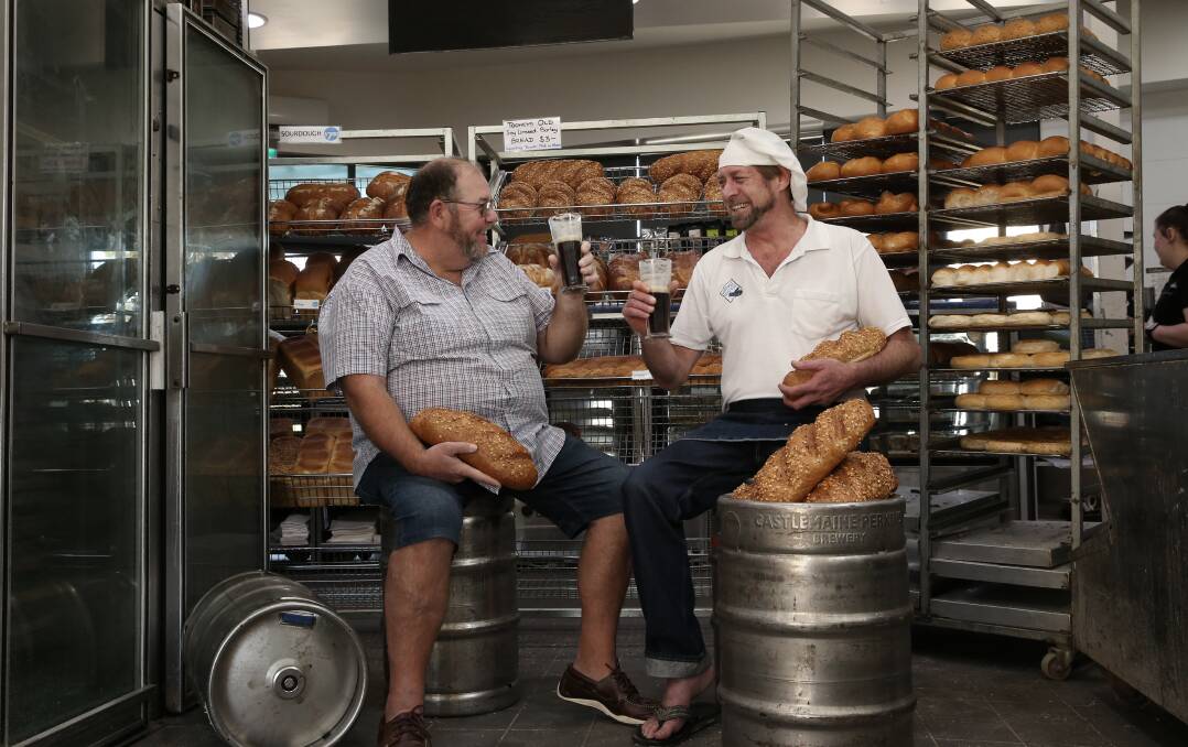 CHEERS: Wayne Izzard, secretary manager of Wangi RSL Club, and baker David Woods toast the creation of the beer bread. Picture: Simone De Peak
