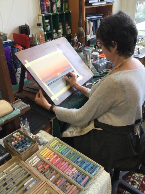 CREATING: Kerrie Coles working on a painting in her home studio. Picture: Supplied