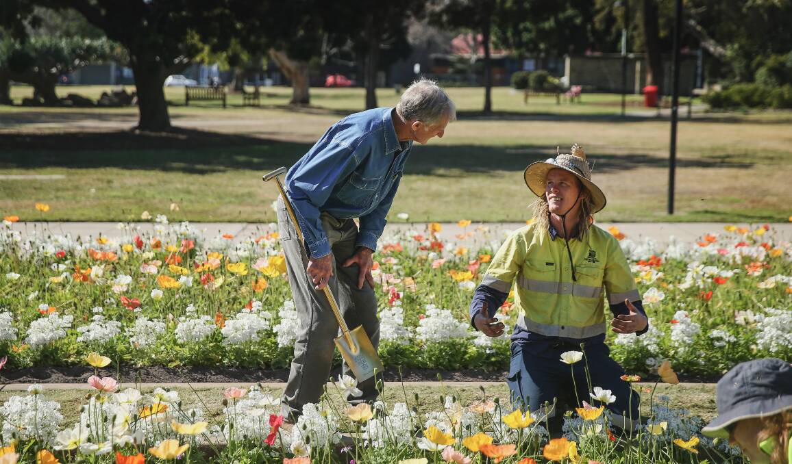 John Le Messurier talks with council horticulturalist Josh Hawkins, while his colleague Rachel Weightman works in the garden in the foreground. Picture: Marina Neil