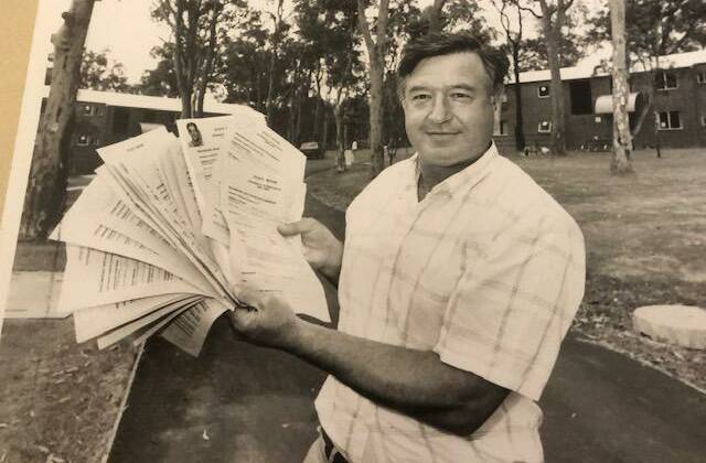 Bernie Curran, photographed at the University of Newcastle in 1990, with applications for Evatt House, the residential college he helped establish. Picture: John Herbert
