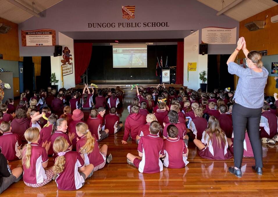 GOLDEN LESSON: Students and staff at Dungog Public School watch the race. Picture: Courtesy, Karina Burke.