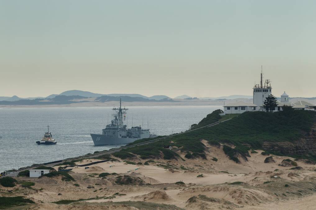 FINAL VISIT: HMAS Newcastle sails into the port of its namesake city for the last time. Picture: Max Mason-Hubers 
