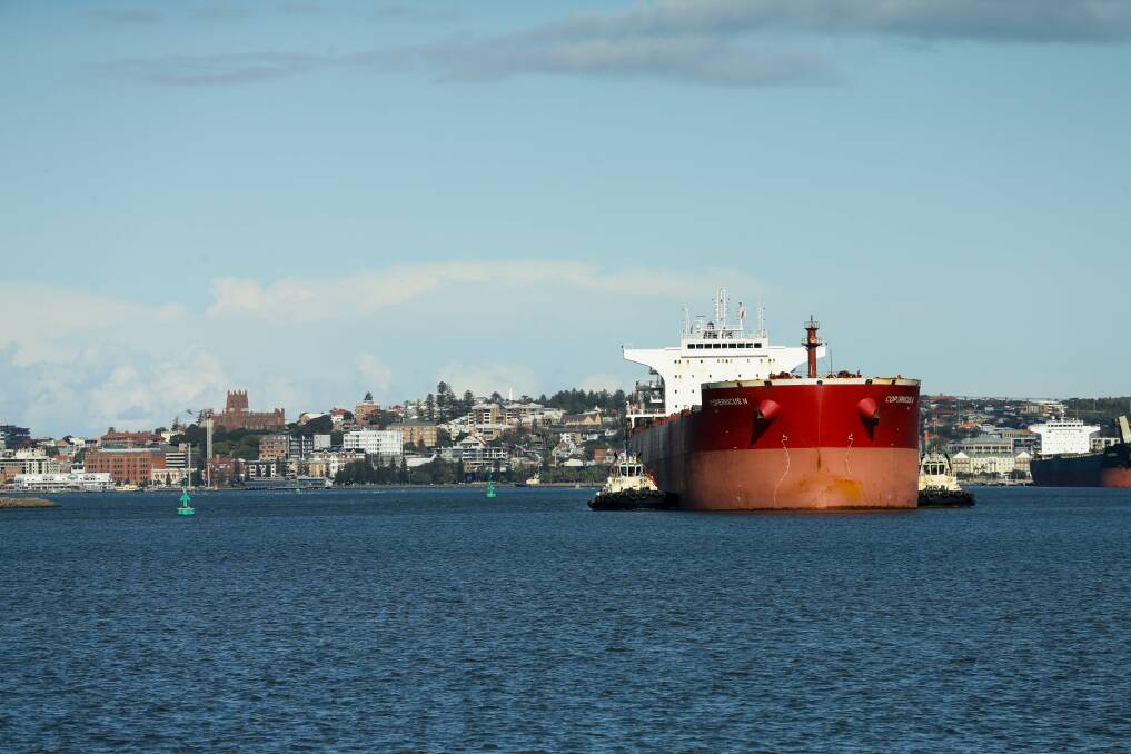 A bulk carrier heading towards Kooragang, with the city of Newcastle in the background. Picture: Jonathan Carroll 