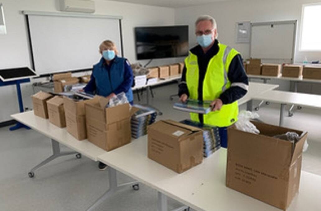 Marine Rescue Lake Macquarie volunteers packing copies of the new book, "Lake Macquarie and its Coastline". Picture: Lee Baines 